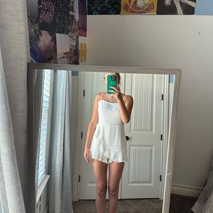 Super cute white romper with bow on the back from boutique